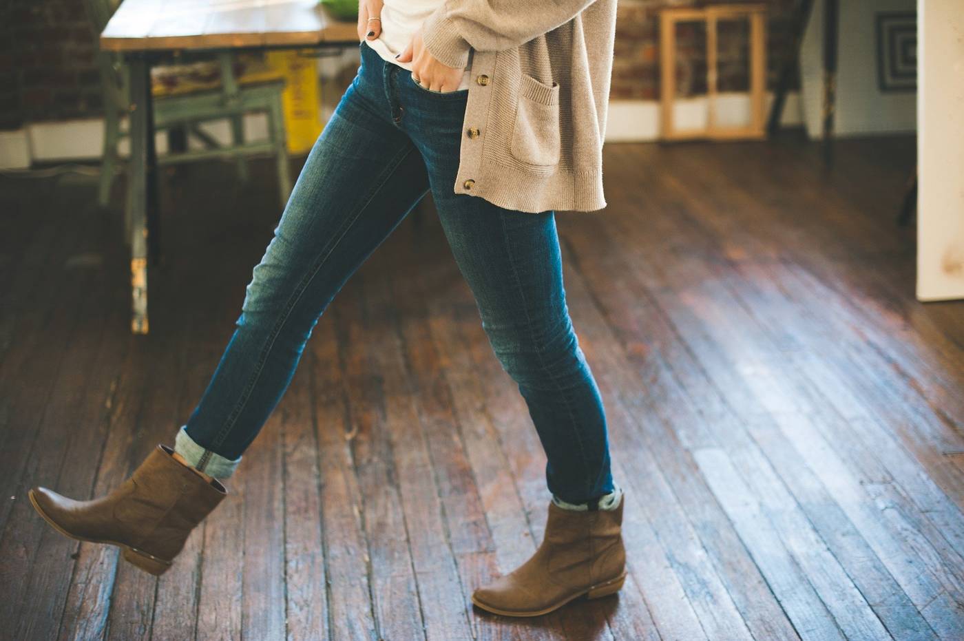 Girl walking on hardwood floor with boots